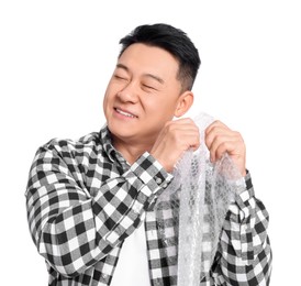 Photo of Happy asian man with bubble wrap on white background