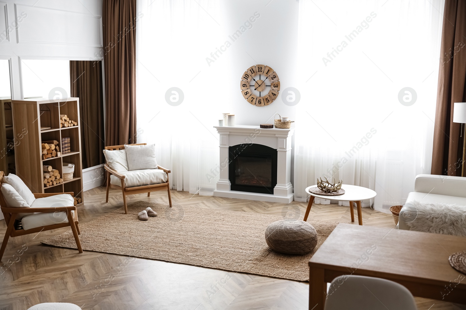 Photo of Elegant artificial fireplace and armchairs in room. Interior design