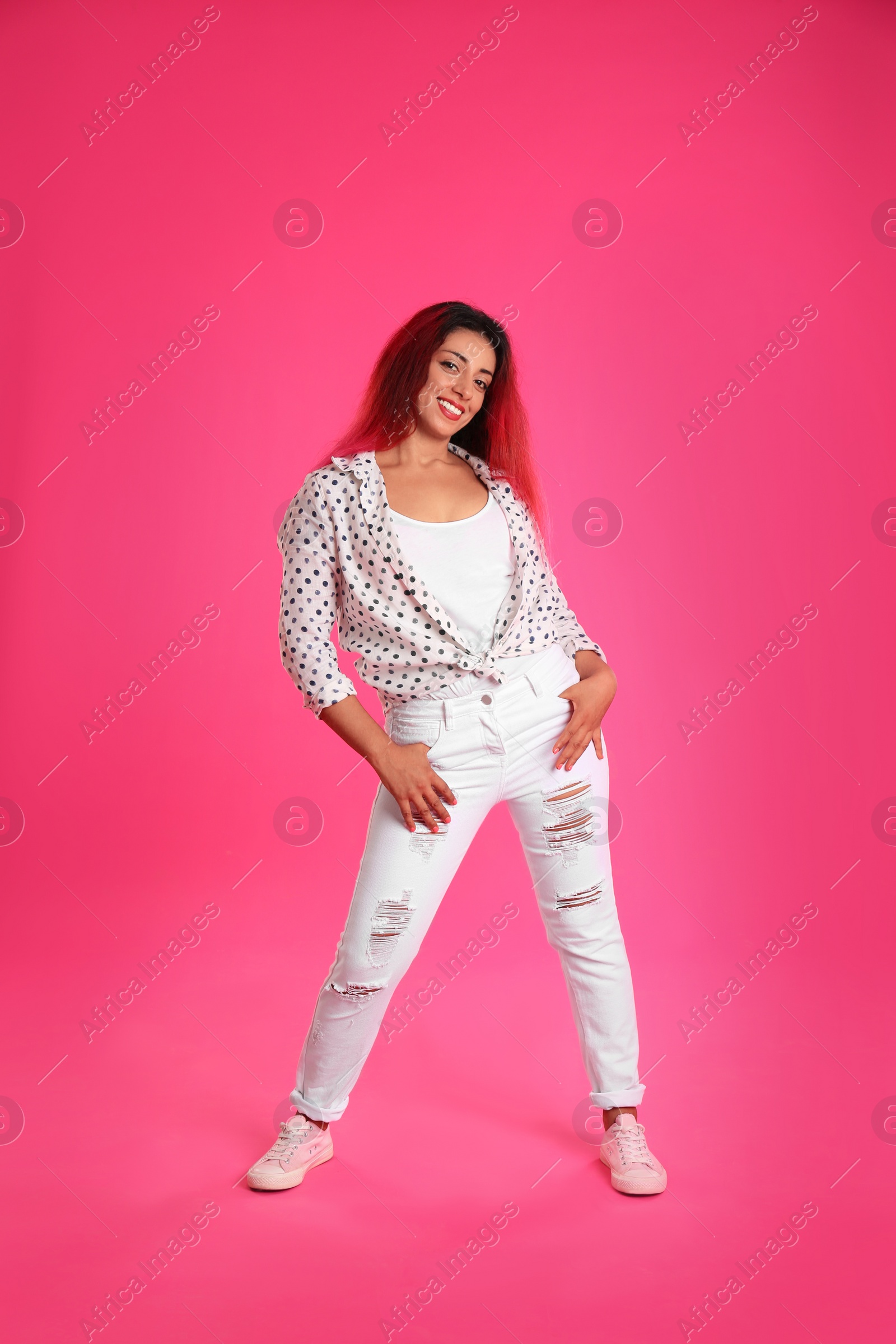 Photo of Beautiful Hispanic woman posing on pink background