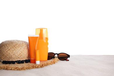 Photo of Sun protection cosmetic products and beach accessories on sand. Space for text