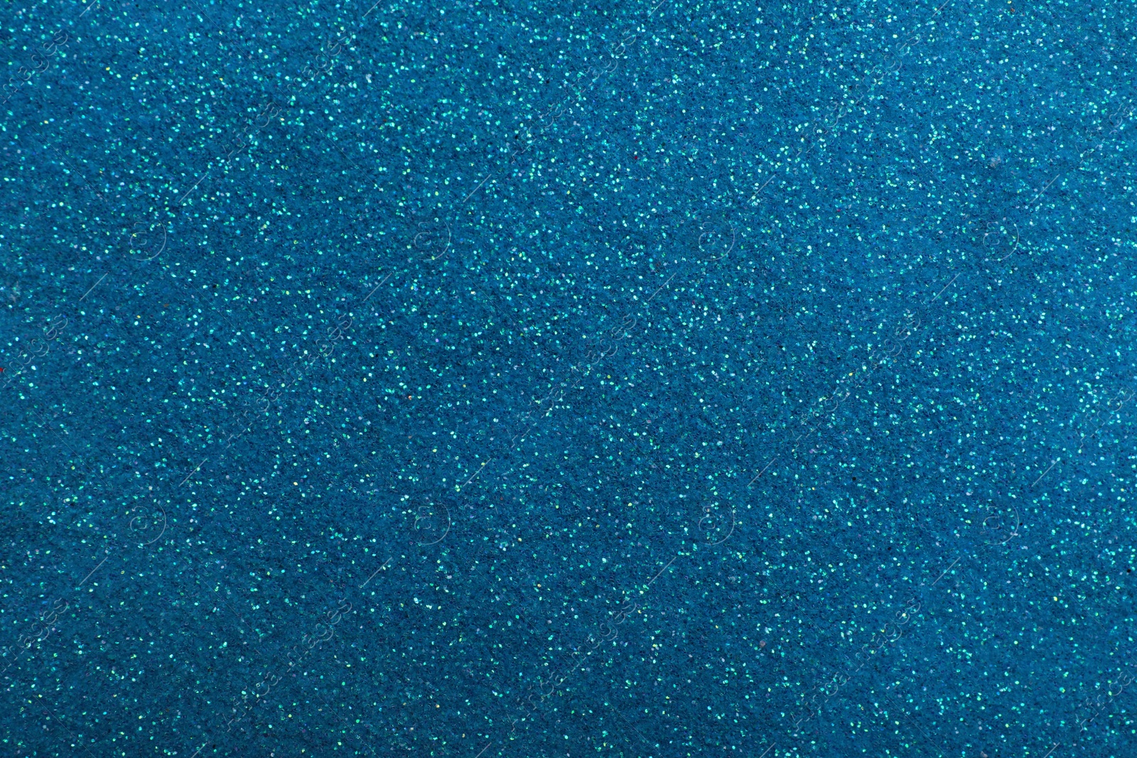 Photo of Shiny light blue glitter as background, closeup