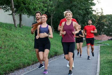 Photo of Group of people running outdoors. Active lifestyle