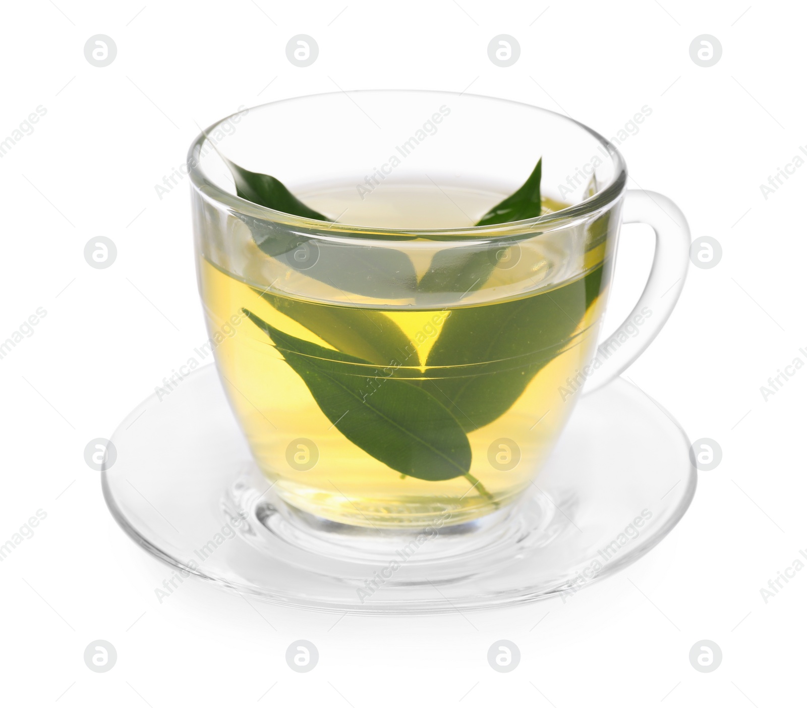 Photo of Fresh green tea in glass cup, leaves and saucer isolated on white