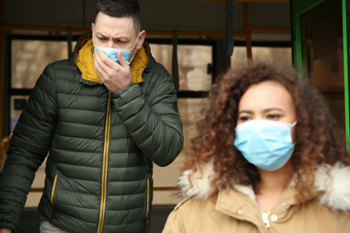 People with disposable masks going out of bus outdoors. Virus protection