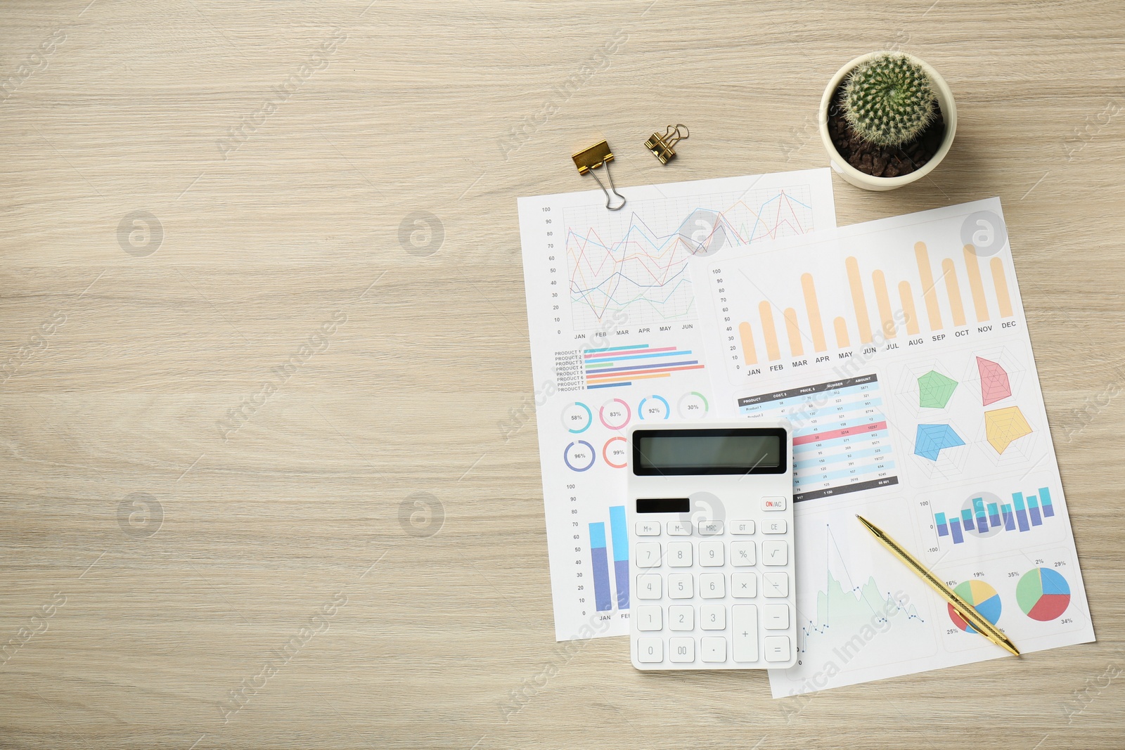 Photo of Accounting documents, calculator, stationery and houseplant on wooden table, top view. Space for text