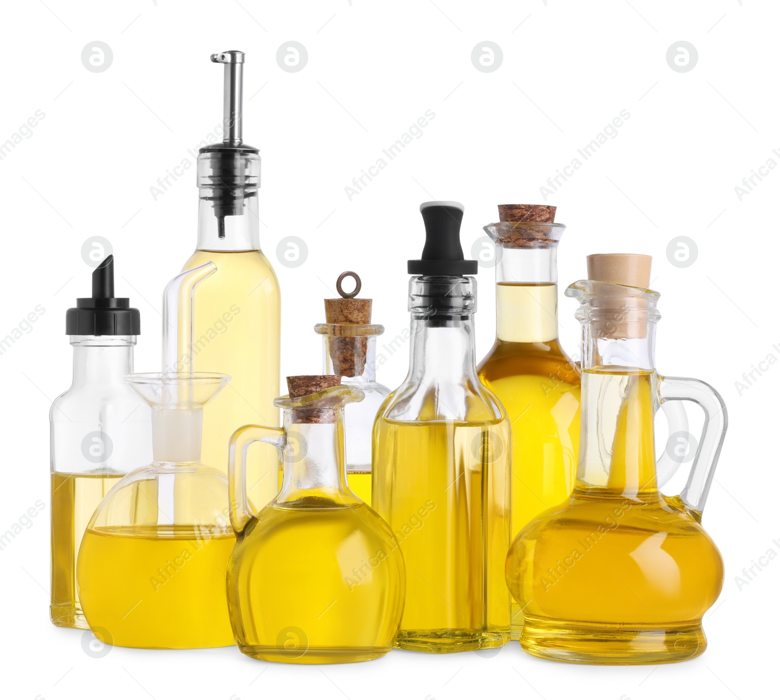 Photo of Different glass bottles of cooking oil on white background