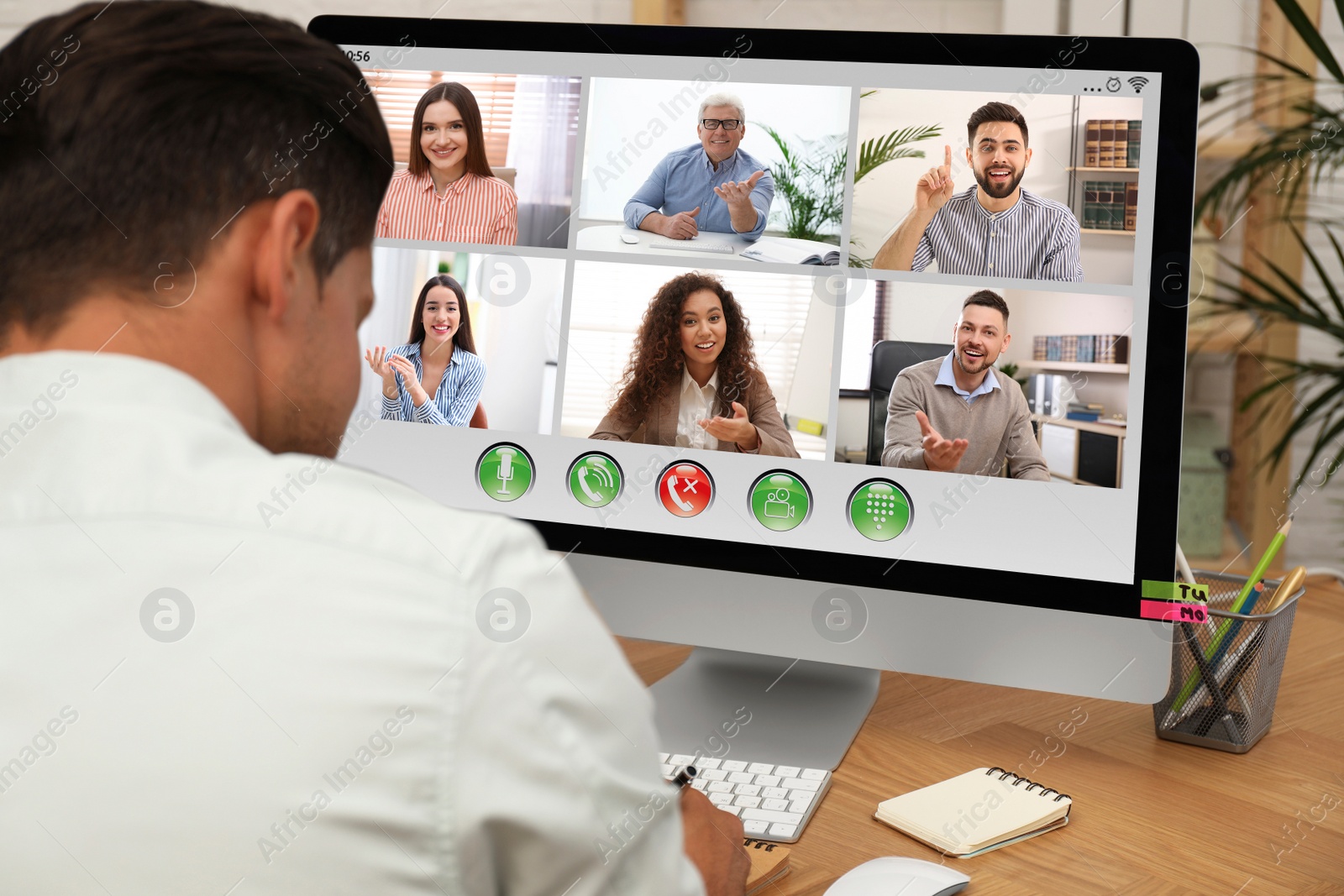 Image of Man having video chat with colleagues at table in office, closeup. Team work 