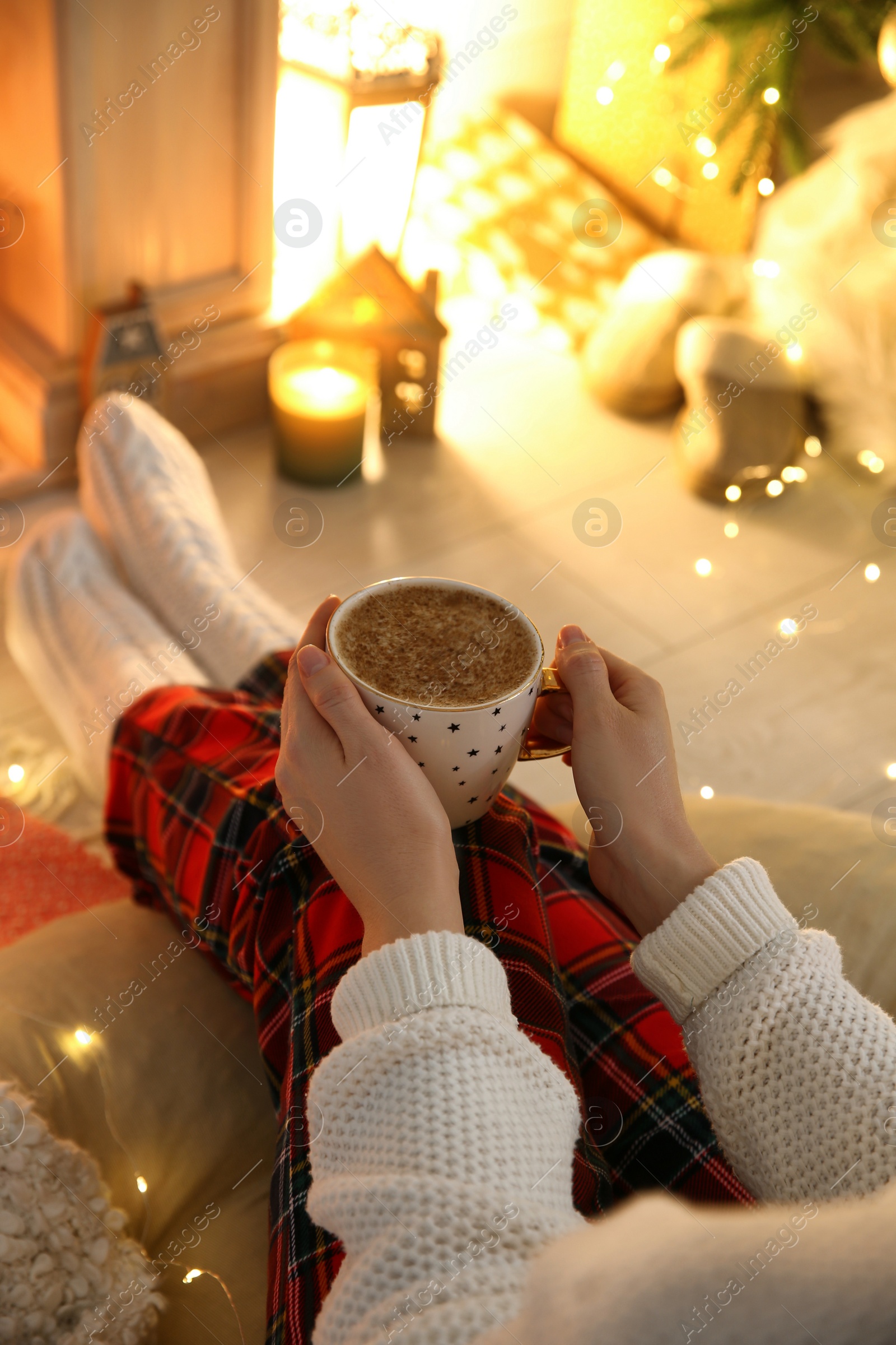 Photo of Woman with cup of hot drink at home, closeup. Christmas celebration