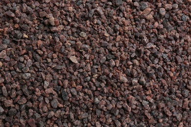 Photo of Pile of black salt as background, top view