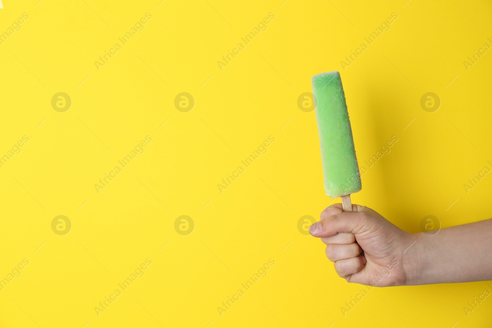 Photo of Woman holding delicious ice cream against color background, space for text