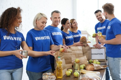 Photo of Team of volunteers collecting food donations indoors
