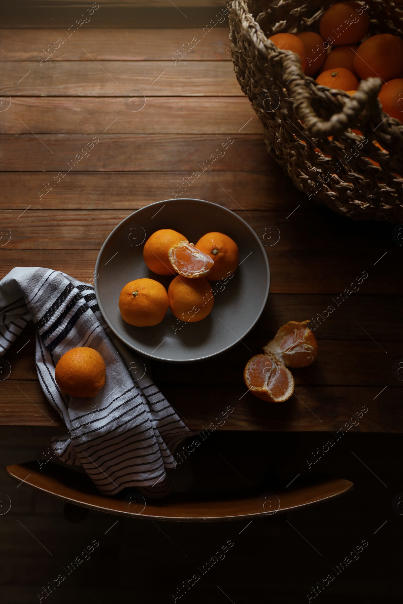 Photo of Fresh ripe tangerines on wooden table, flat lay