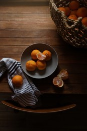 Photo of Fresh ripe tangerines on wooden table, flat lay