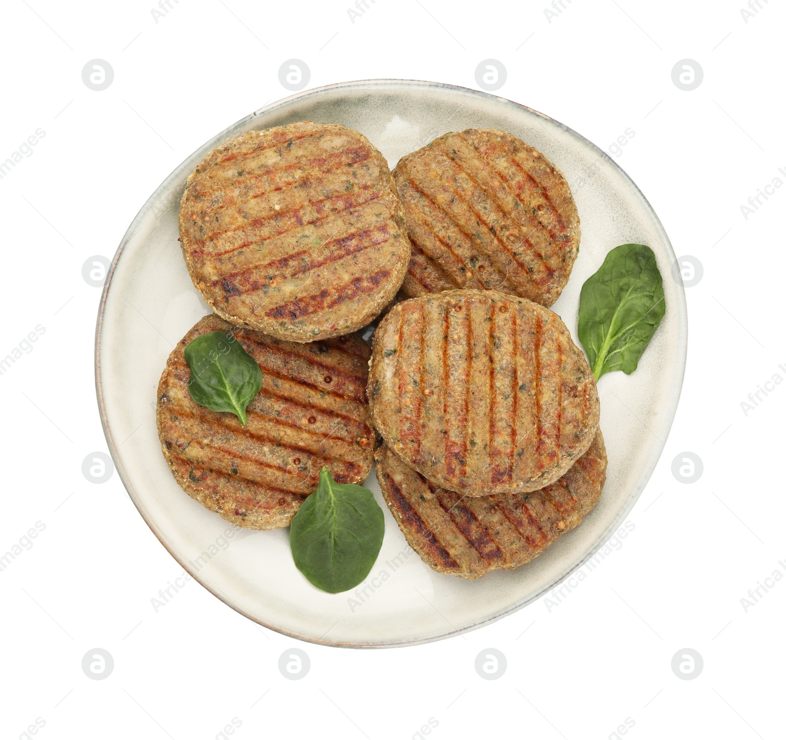 Photo of Plate of delicious grilled vegan cutlets and spinach isolated on white