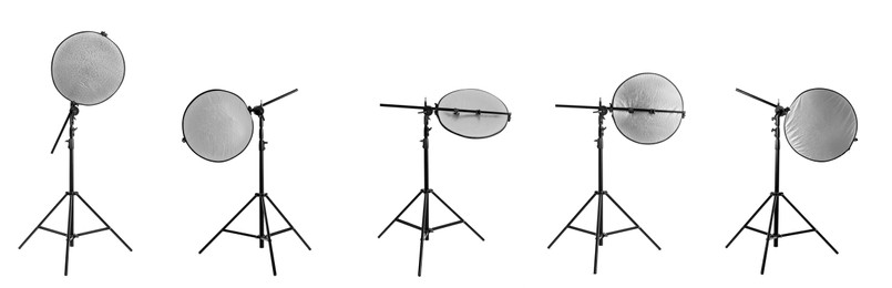 Image of Set of tripods with reflectors on white background, banner design. Professional photographer's equipment