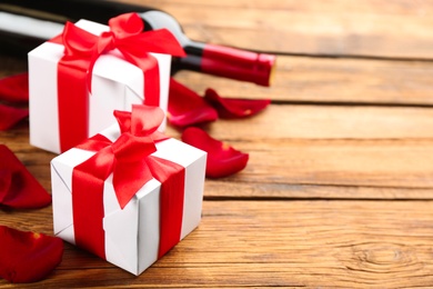 Photo of Beautiful gift boxes on wooden table, space for text. Valentine's Day celebration