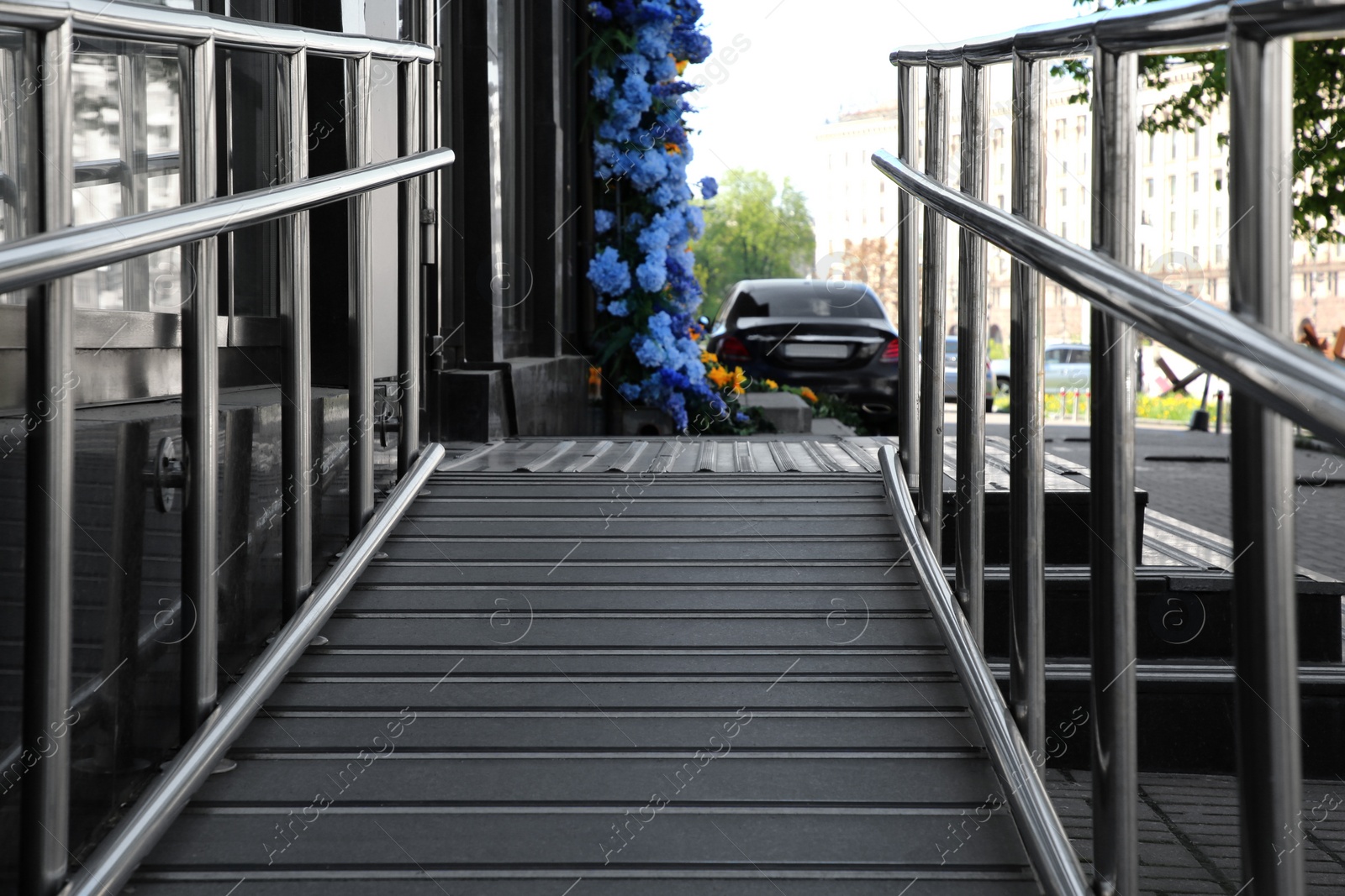 Photo of Ramp with metal railings near building outdoors