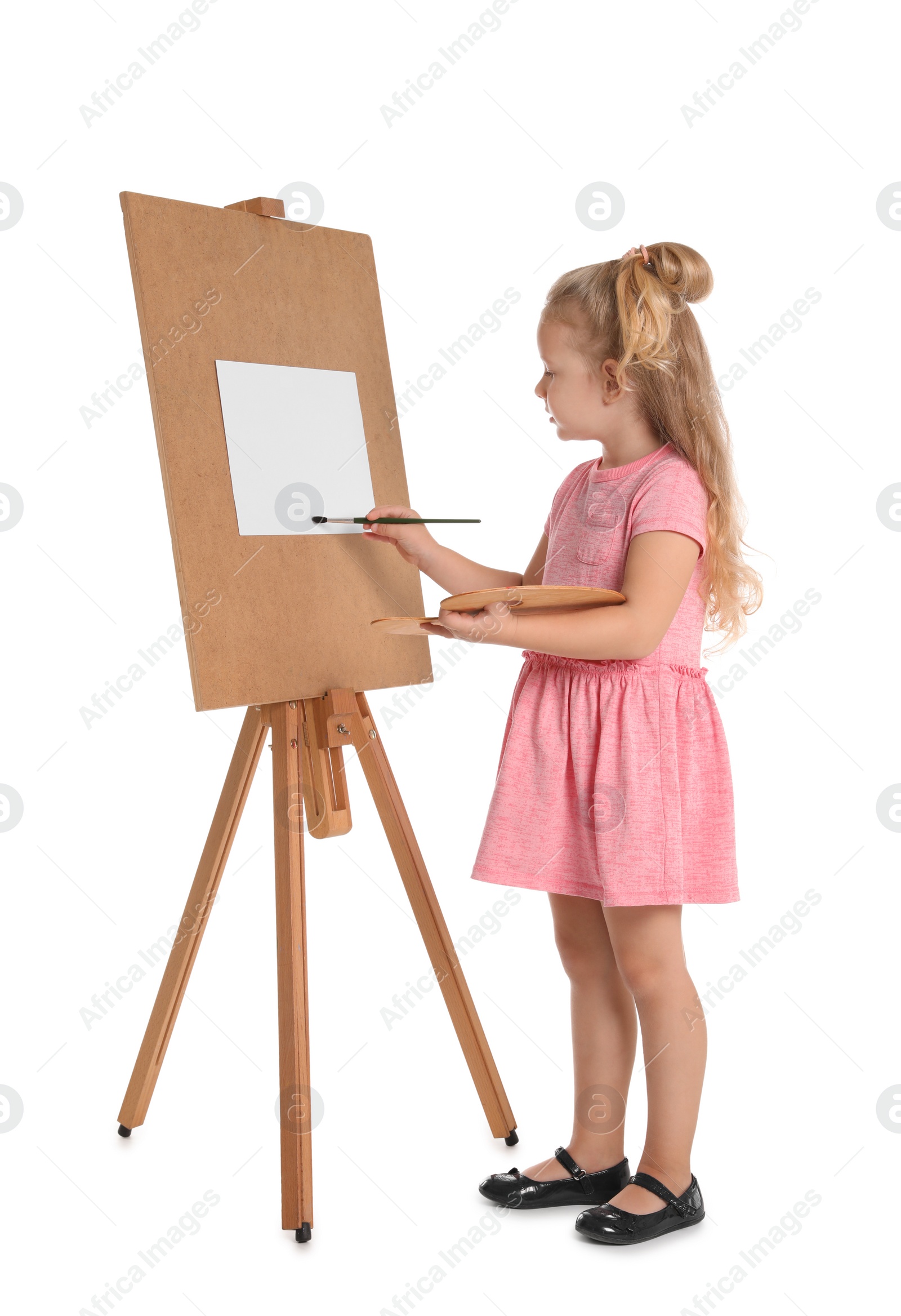 Photo of Child painting picture on easel against white background. Space for text