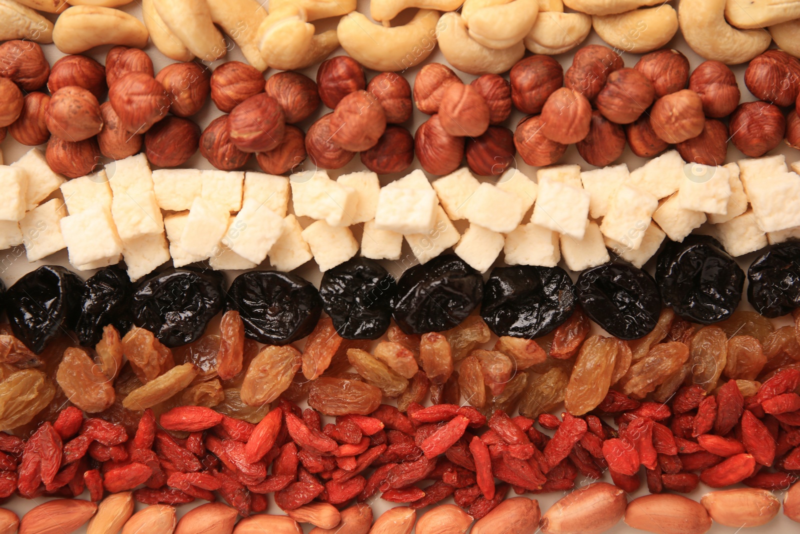 Photo of Different tasty nuts and dried fruits as background, top view