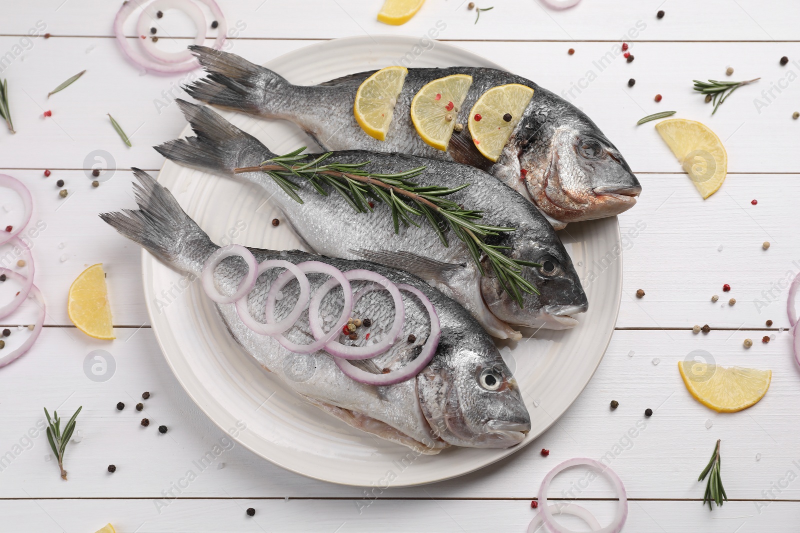 Photo of Flat lay composition with raw dorado fish and spices on white wooden table