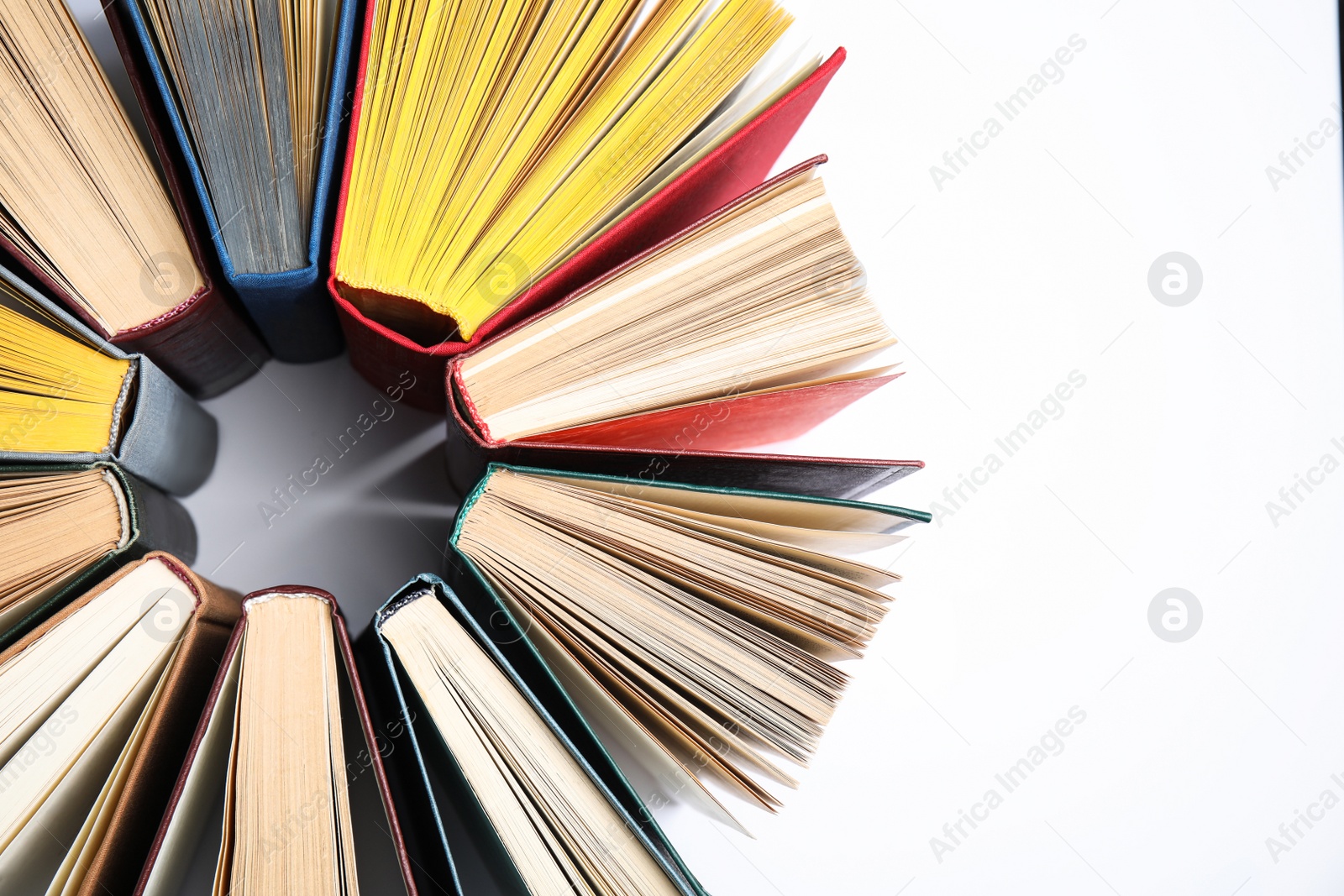 Photo of Circle made of hardcover books on white background, flat lay