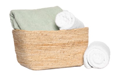 Wicker basket and soft terry towels on white background