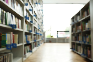 Photo of Blurred view of path between bookcases in library