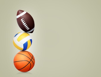 Image of Stack of different sport balls on beige background, space for text