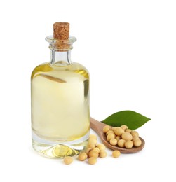 Photo of Glass bottle of oil, soybeans and leaf on white background