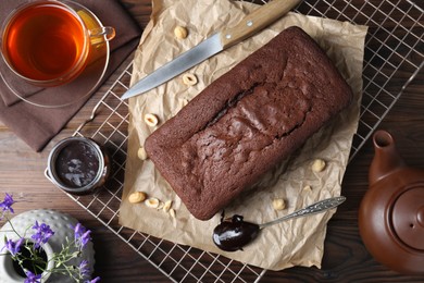 Photo of Flat lay composition with delicious chocolate sponge cake on wooden table