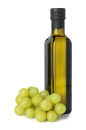 Photo of Vegetable fats. Bottle of cooking oil and fresh grapes isolated on white