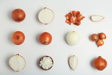 Photo of Flat lay composition with ripe onions on light background