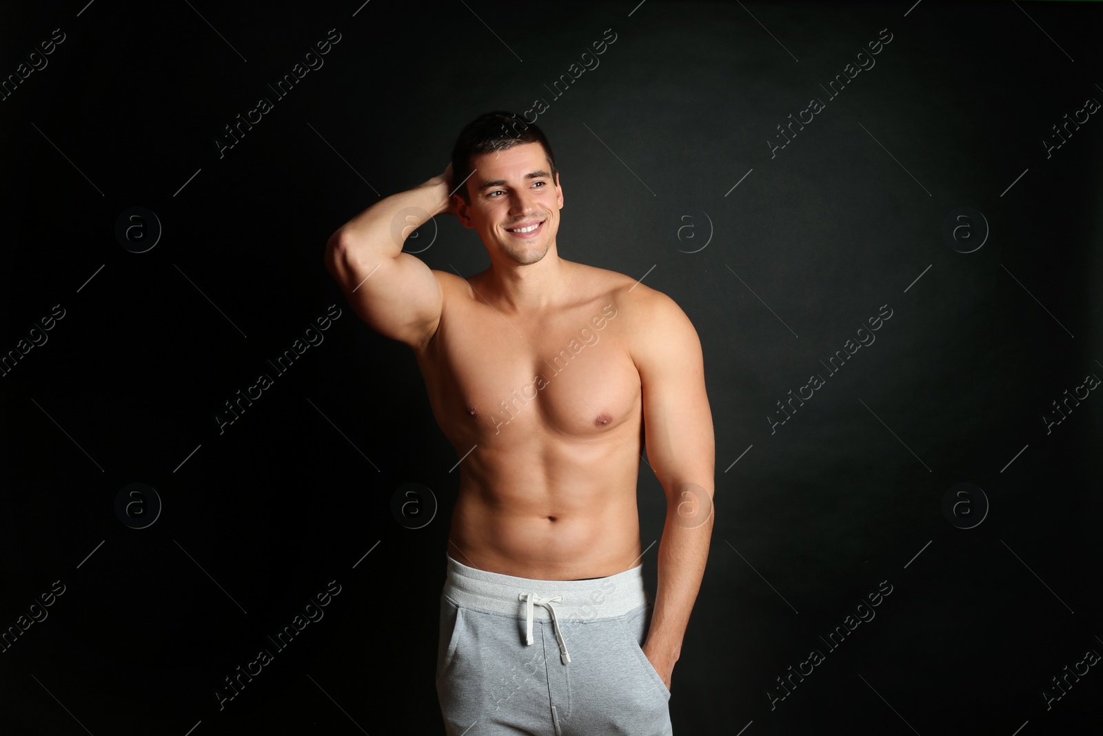 Photo of Man with sexy body on black background