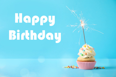 Delicious cupcake with sparkler on light blue background. Happy Birthday 