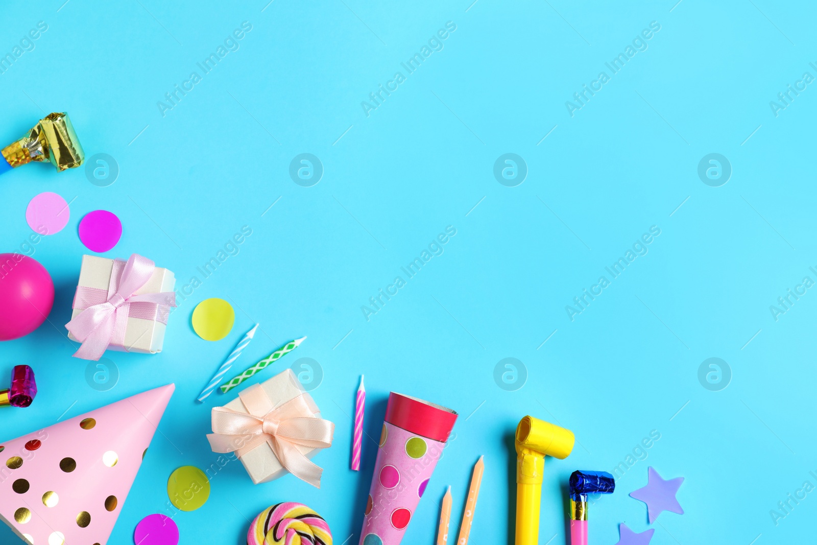 Photo of Flat lay composition with different birthday party items on light blue background, space for text