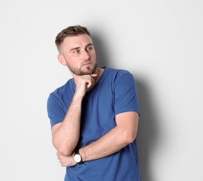 Photo of Portrait of handsome thoughtful man on white background