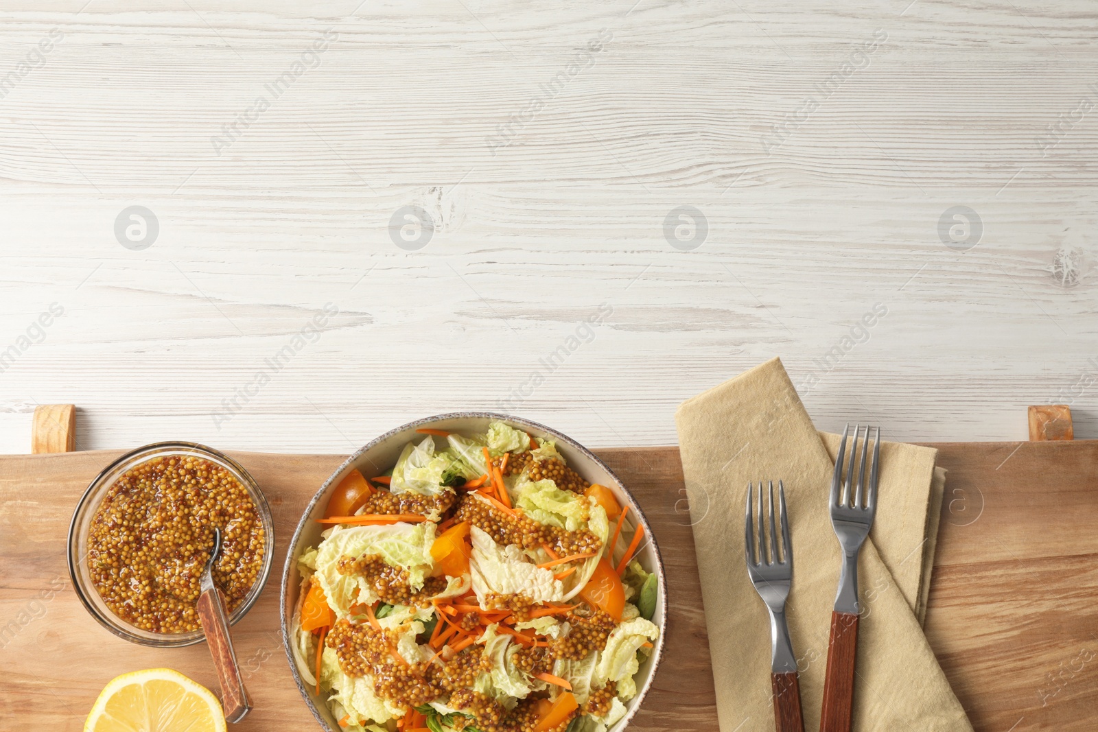 Photo of Delicious salad with Chinese cabbage and mustard seed dressing on white wooden table, top view. Space for text