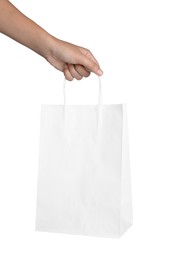 Woman holding shopping paper bag on white background