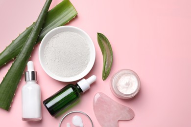 Photo of Flat lay composition with cosmetic products and cut aloe leaves on pink background. Space for text