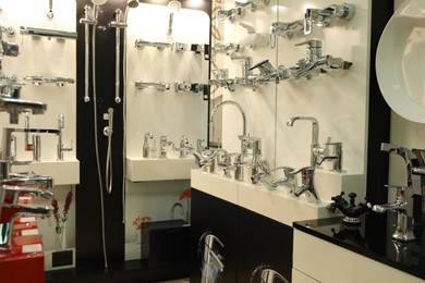 Photo of Assortment of metal water taps in store