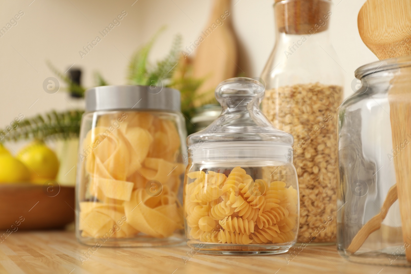 Photo of Jars with products on wooden kitchen countertop