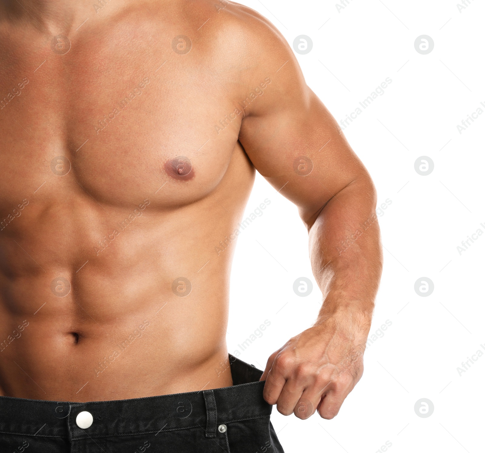 Photo of Young man with slim body in old big size jeans on white background, closeup view