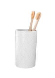 Bamboo toothbrushes in holder isolated on white