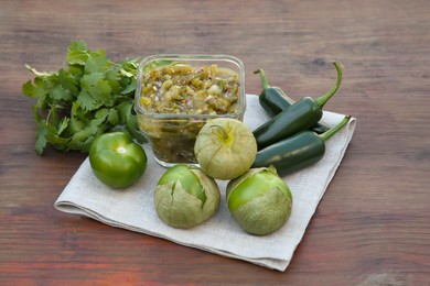 Tasty salsa sauce and ingredients on wooden table