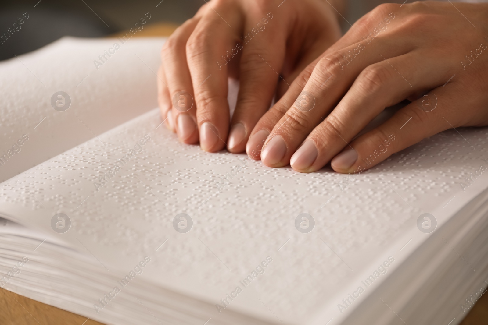 Photo of Blind man reading book written in Braille, closeup