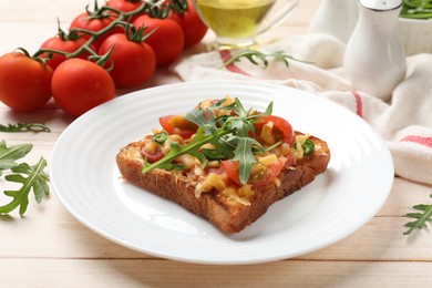 Tasty pizza toasts and ingredients on light wooden table