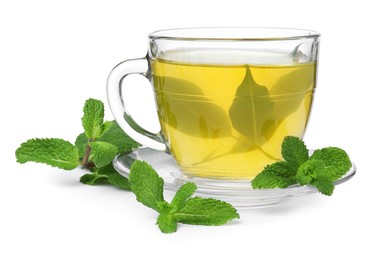 Fresh green tea in glass cup, mint and saucer isolated on white