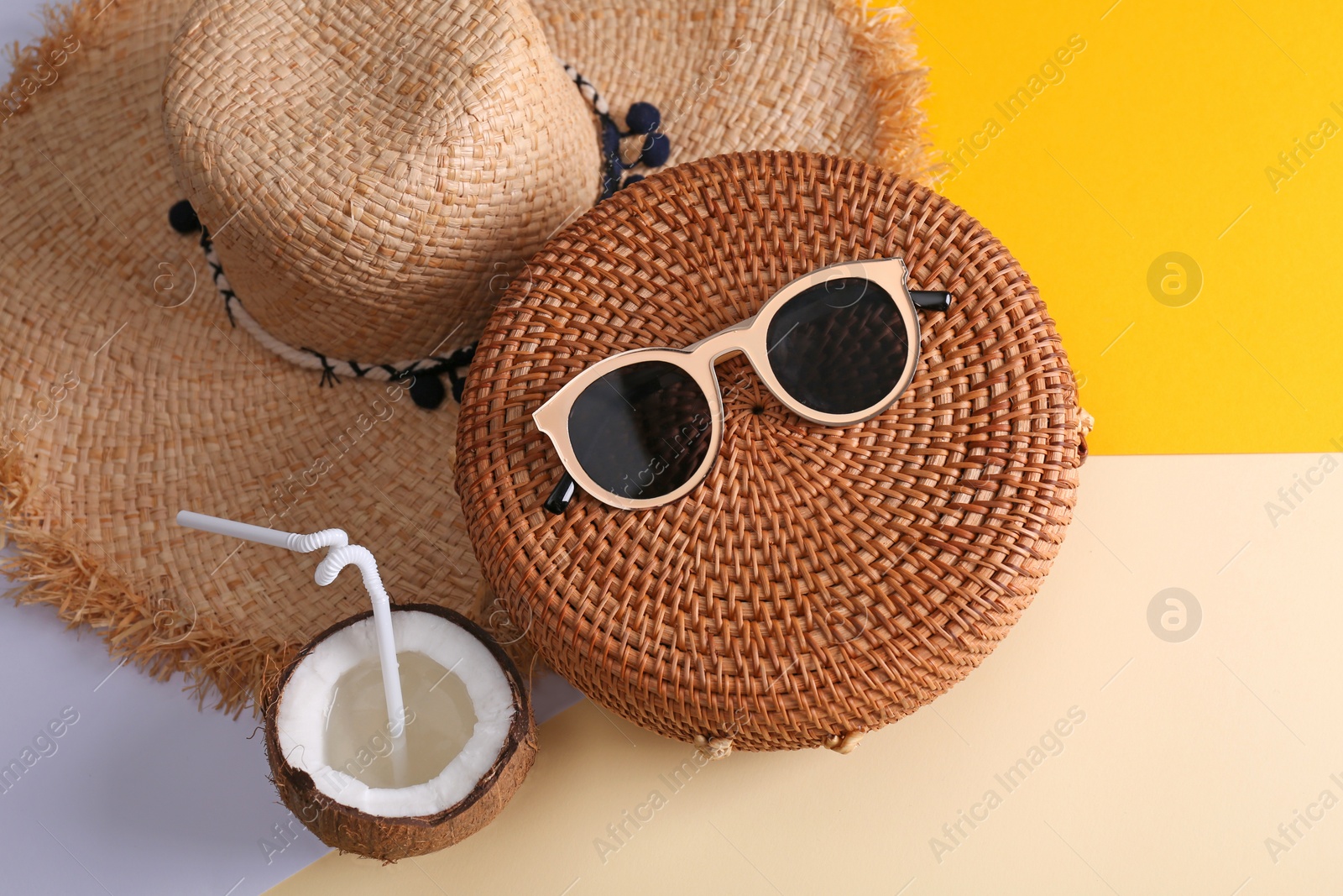 Photo of Bamboo bag and beach items on color background