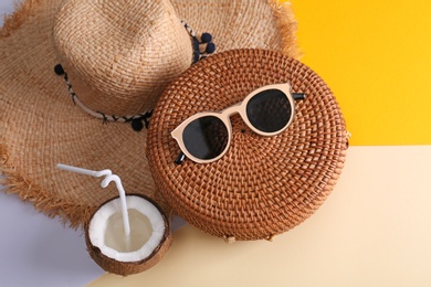 Photo of Bamboo bag and beach items on color background