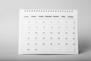 Photo of Paper calendar on grey background. Planning concept
